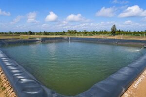 Completed aquaculture pond lined with PVC liner holding water