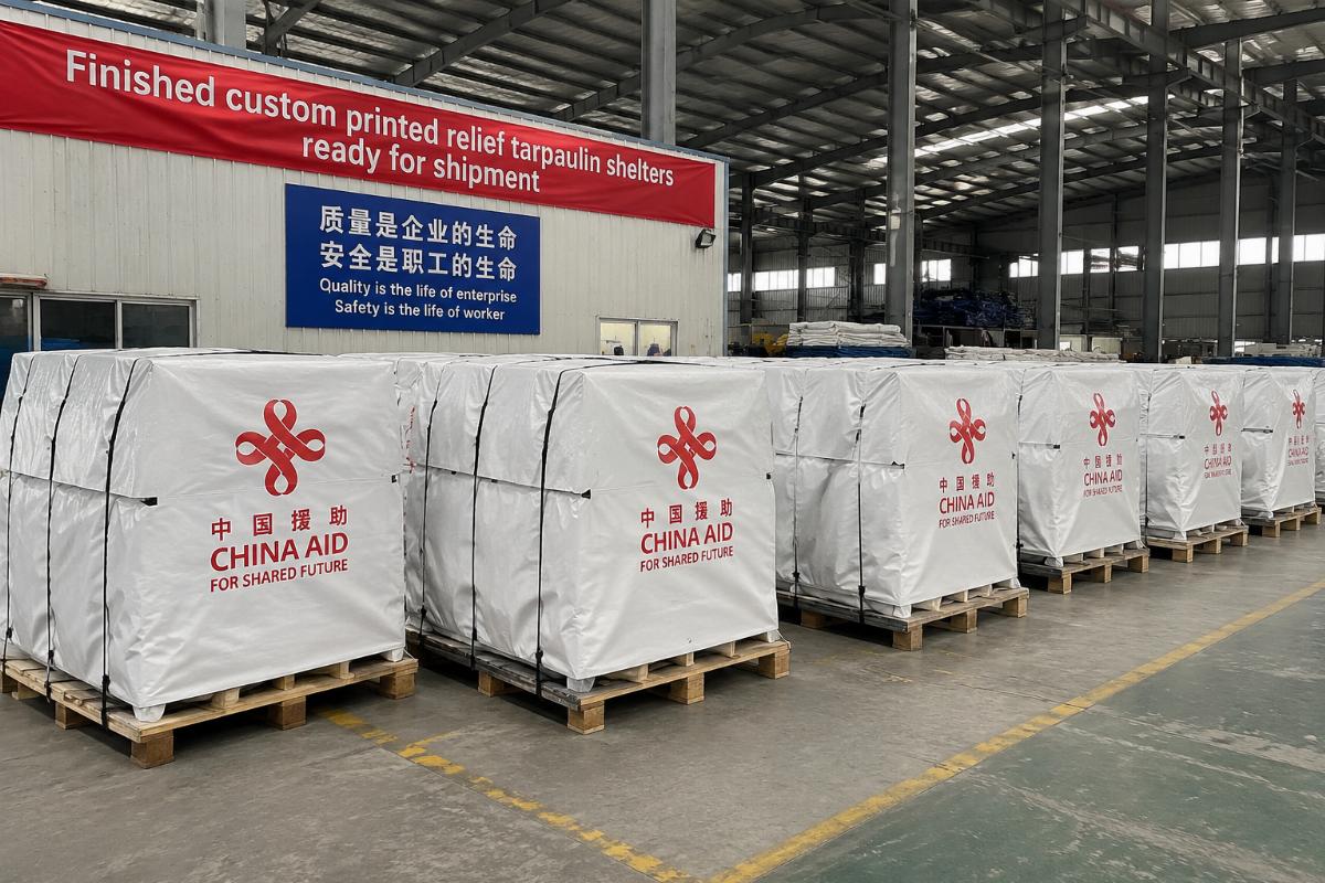 Finished custom printed relief tarpaulin shelters ready for shipment at a Chinese factory warehouse